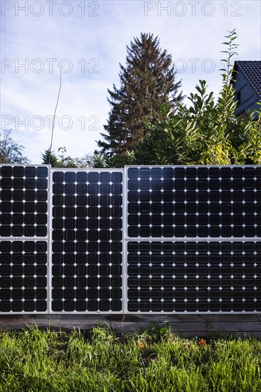 Solar panels as a garden fence and privacy screen of a house on a street in Langenfeld