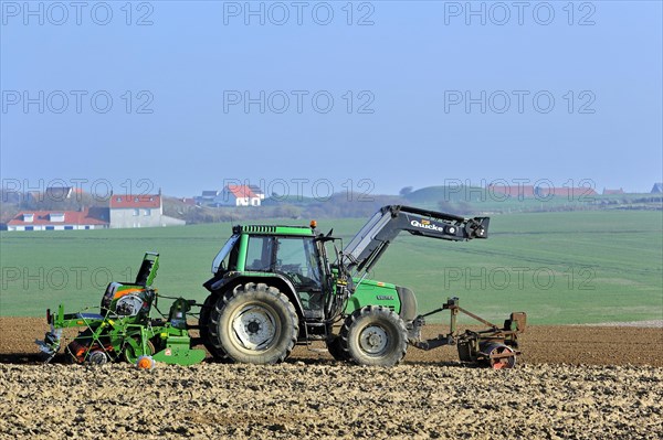 Tractor sowing seeds with seed drill