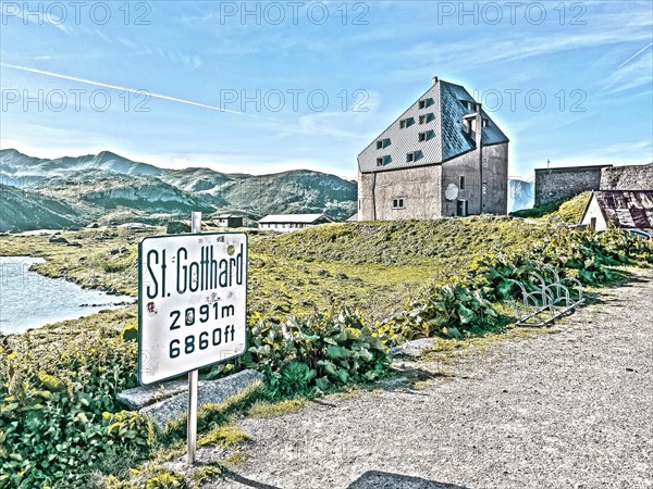 Photo with reduced dynamics saturation HDR of view to the left at the edge of the picture mountain lake in the foreground sign for pass Sankt St Gotthard Gotthard pass 2091 metres altitude high mountain pass alpine mountain road pass road old Gotthard road