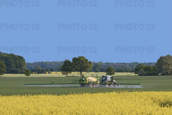 Farmer in tractor spraying herbicides