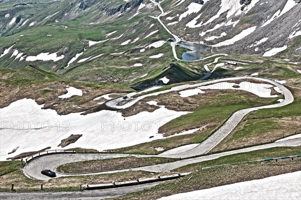 Photo with reduced dynamics saturation HDR of mountain pass alpine mountain road alpine road pass road pass old Grossglockner High Alpine Road Grossglockner High Alpine Road with serpentines with cobblestones in front