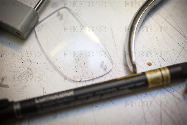 A lens on a worktop in an optician's shop