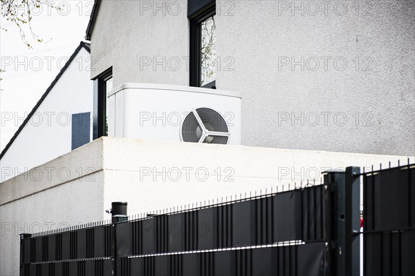 Heat pump on a garage roof of a new development