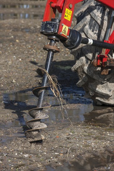 Tractor equipped with earth auger