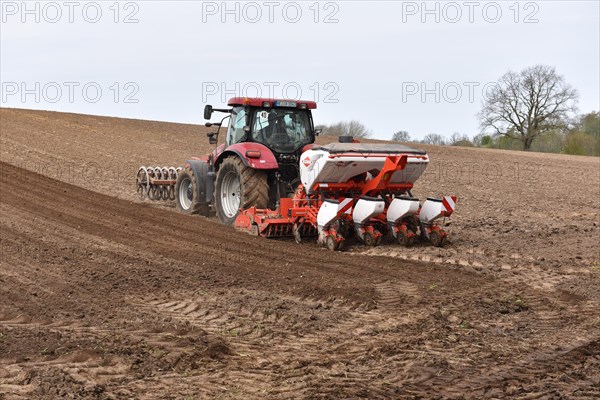 Tractor with seed drill in a field