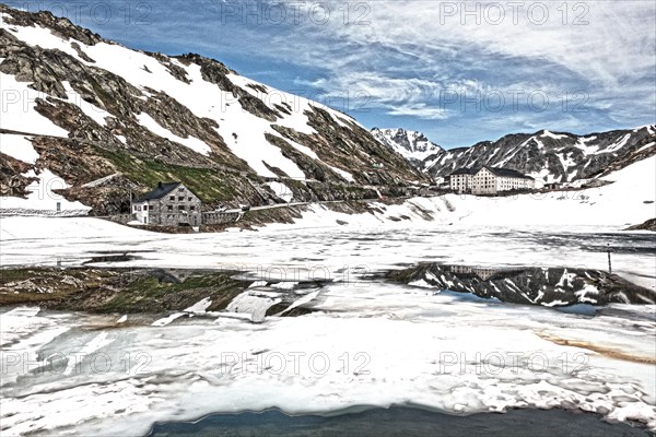 Photo with reduced dynamic saturation HDR of mountain pass alpine mountain road alpine road pass road pass with snow and ice on mountain lake lake at Great Saint Bernard Pass