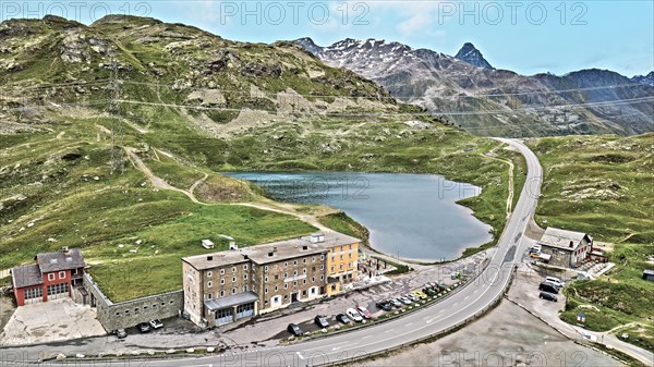 Photo with reduced dynamics saturation HDR of mountain lake at mountain pass alpine mountain road alpine road pass road Bernina Pass Bernina Pass