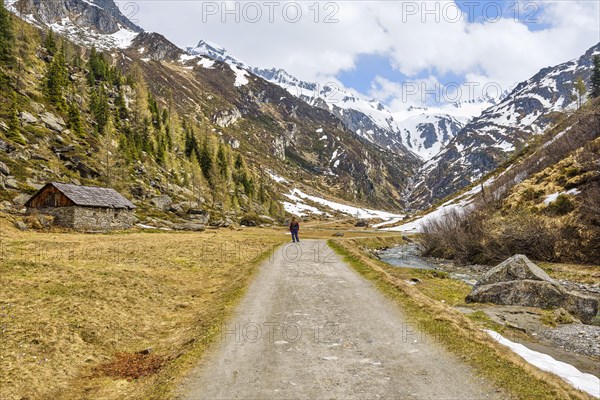 Hiker next to alpine hut in Ahrntal