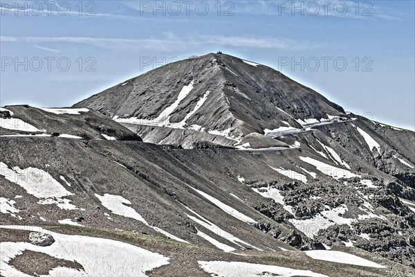 Photo with reduced dynamic saturation HDR of mountain pass alpine mountain road alpine road pass road pass view of highest asphalted alpine road ring road around Cime de la Bonette Col de la Bonette in high mountains above tree line