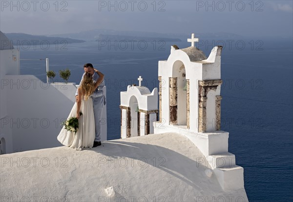 Taking wedding photos atop the roof of Chapel of St John the Baptist