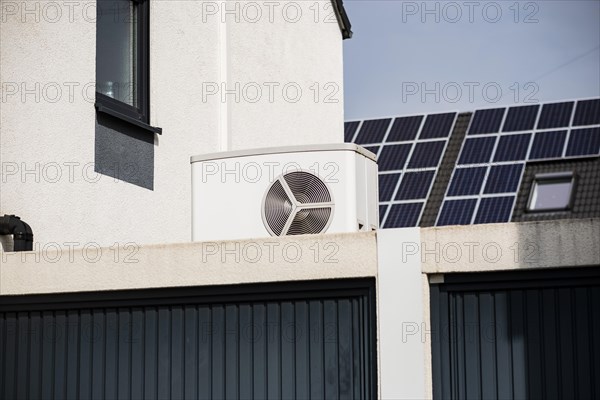 Heat pump on a garage roof of a new development