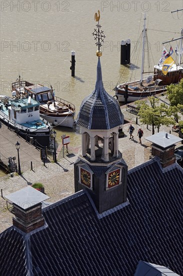 Ships in the museum harbour with the tower of the Alte Waage seen from the town hall tower