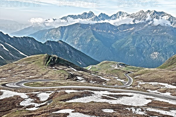 Photo with reduced dynamics saturation HDR of mountain pass alpine mountain road alpine road pass road pass Grossglockner-Hochalpenstrasse Grossglockner High Alpine Road on alpine plateau above tree line
