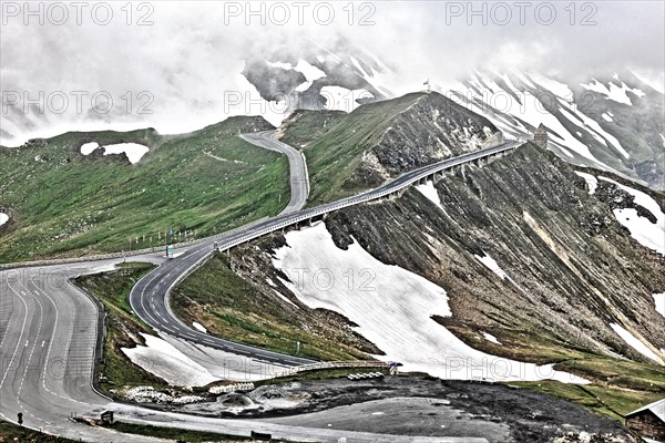 Photo with reduced dynamic saturation HDR of mountain pass alpine mountain road alpine road pass road pass old Grossglockner High Alpine Road Grossglockner High Alpine Road without cars no traffic above above tree line