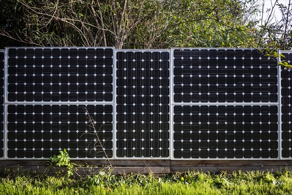 Solar panels as a garden fence and privacy screen of a house on a street in Langenfeld