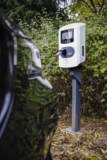 An e-car being charged at a private charging station