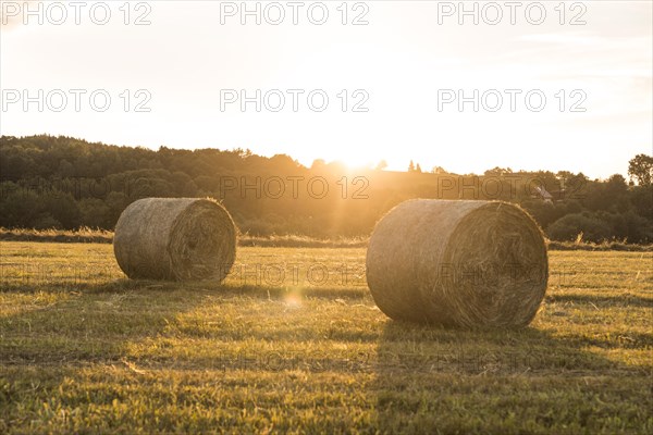 Beautiful landscape with rolls hays sunset