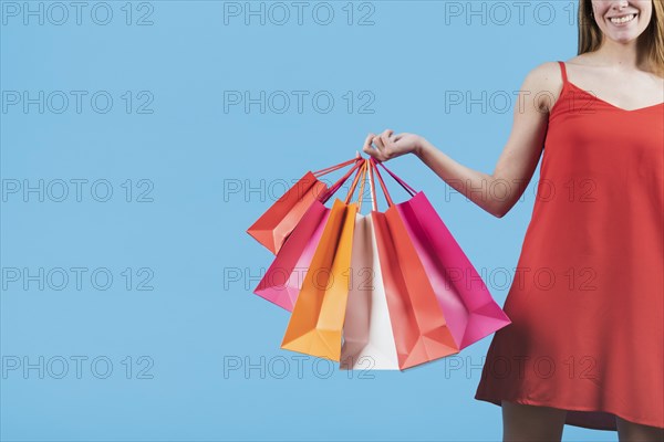Girl with shopping bags plain background
