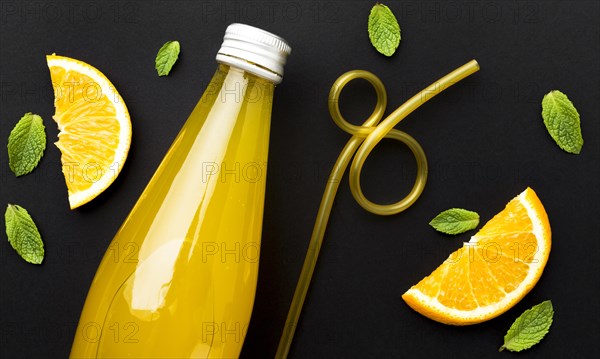 Top view bottle with soft drink orange slices