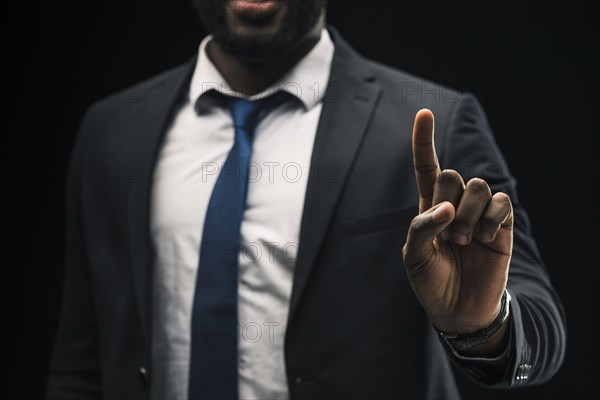 Ethnic businessman pointing up