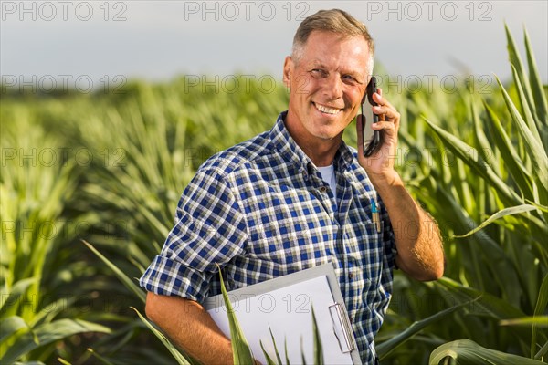 Man talking phone field