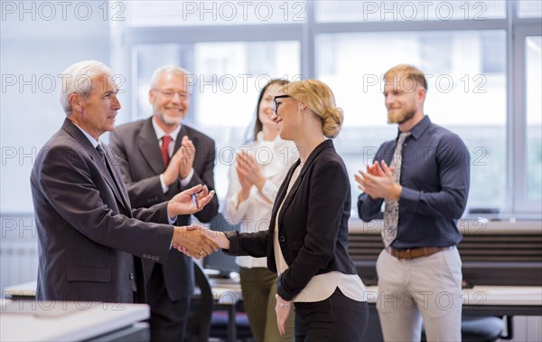 Business people shaking hands after successful negotiations office