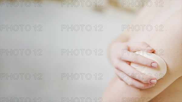 Anonymous girl washing with soap
