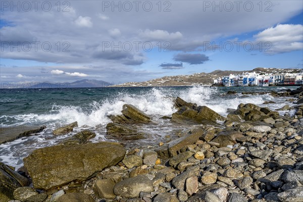 Waves breaking between the rocks on the beach