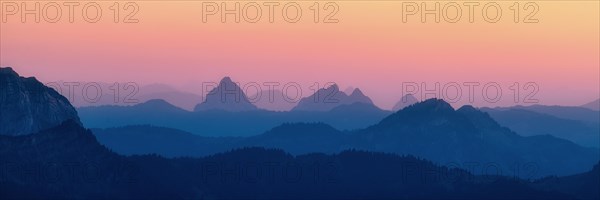 Panorama hilly landscape with mountains Kleiner and Grosser Mythen after sunset