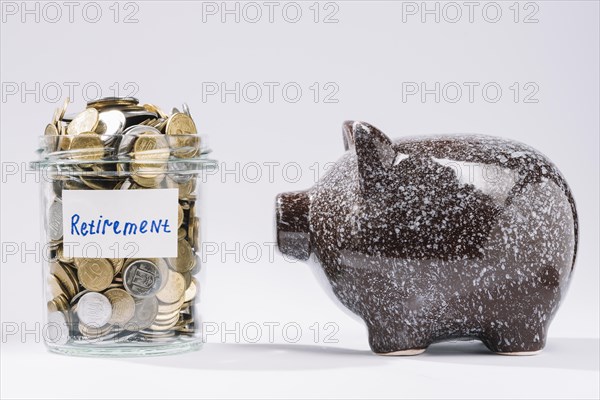 Piggybank near retirement glass container full coins