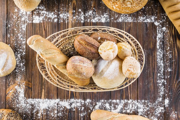 Loaves bread basket inside rectangular frame made with flour