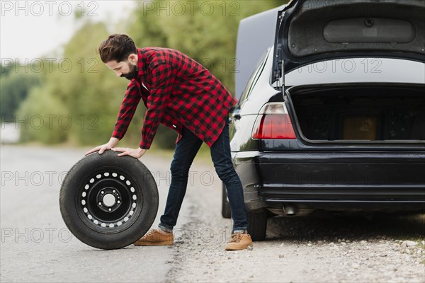 Side view man with spare tyre