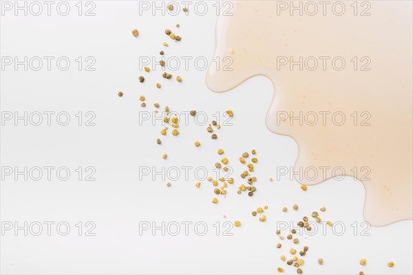 High angle view honey bee pollen seeds white background