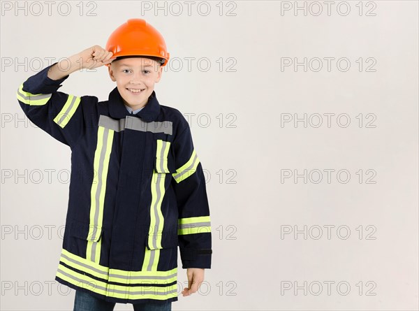 Adorable young fireman copy space
