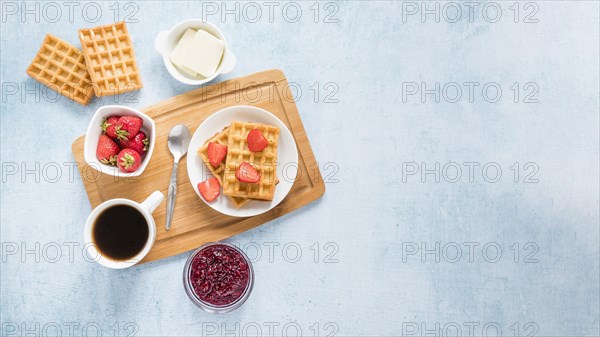 Board with waffles fruits with copy space