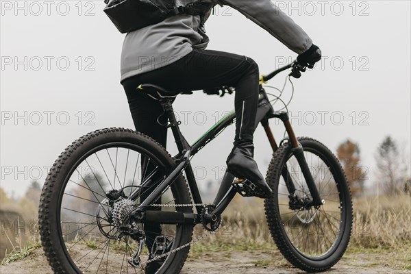 Front view man riding bike