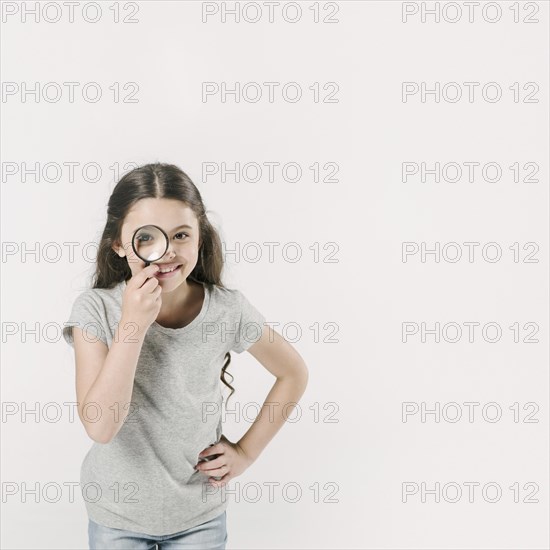 Girl standing studio with loupe