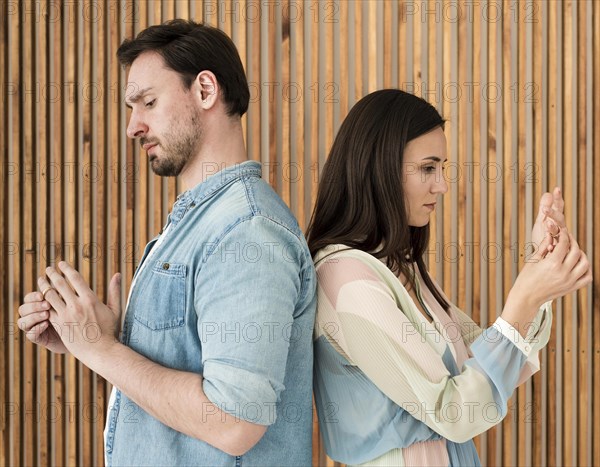 Adult man woman taking wedding rings off