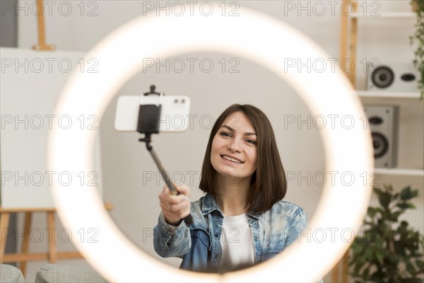 Beautiful woman recording herself home