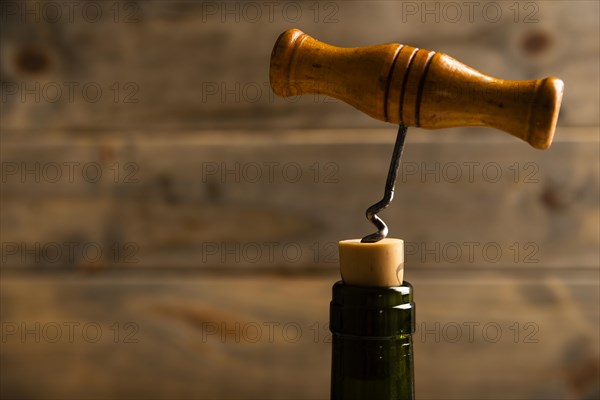 Close up corkscrew with wooden background