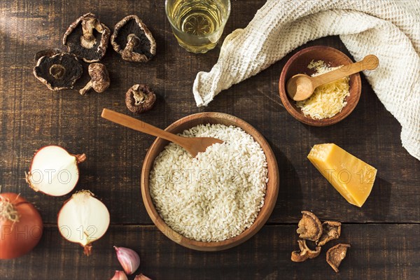 Ingredients making risotto fungi rustic wooden table