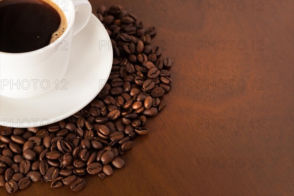 Partial view coffee cup beans wooden table
