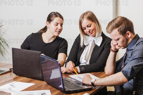 People sitting desk talking