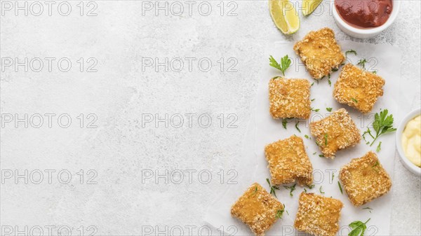 Top view fried chicken nuggets with sauces copy space