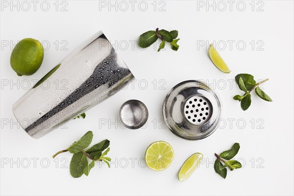 Flat lay cocktail ingredients with shaker mint