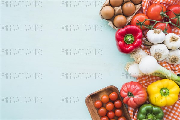 Eggs healthy vegetables blue colored background