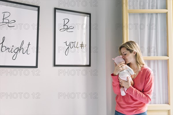 Woman holding baby frames with quotes