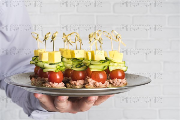 Chef holding plate with catering food