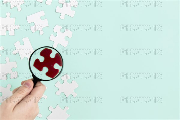 Puzzle pieces with magnifier