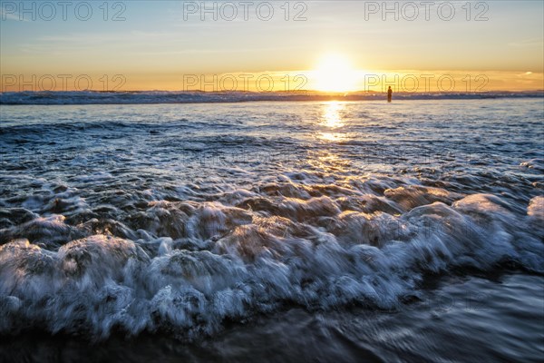 Atlantic ocean sunset with surging waves at Fonte da Telha beach